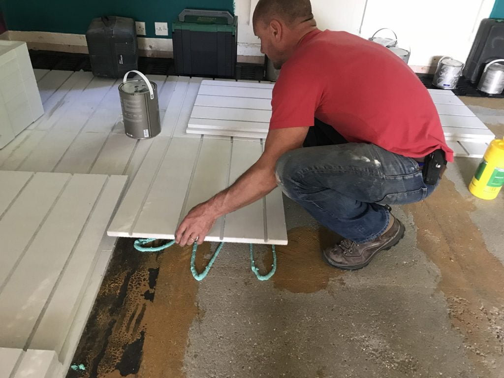 man installing the water underfloor heating